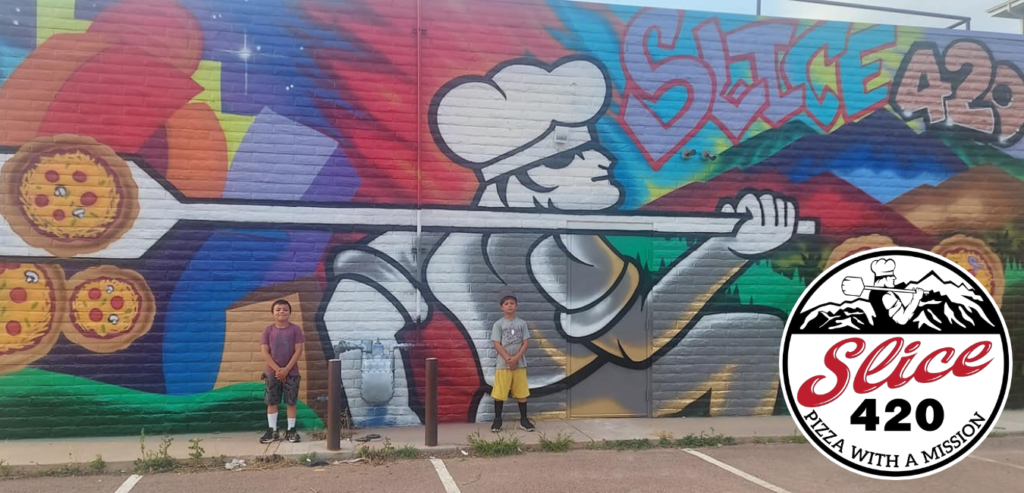 Large wall mural of pizza chef and pizza pies with 2 adolescent children posing with Slice420 logo